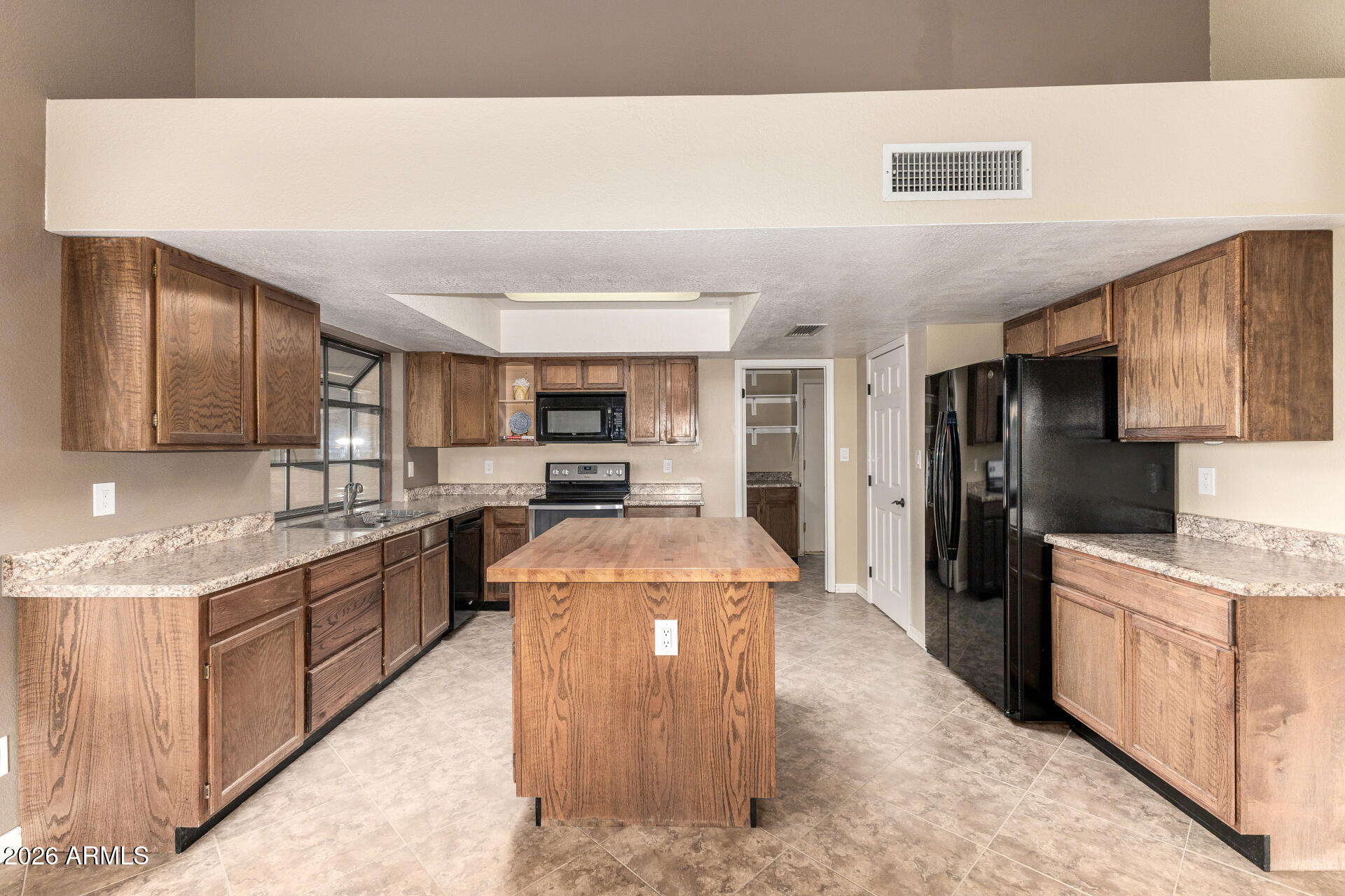 1522 N Spring Mesa, AZ 85203 - Photo 11 of 63 a large kitchen with stainless steel appliances kitchen island a sink stove and refrigerator