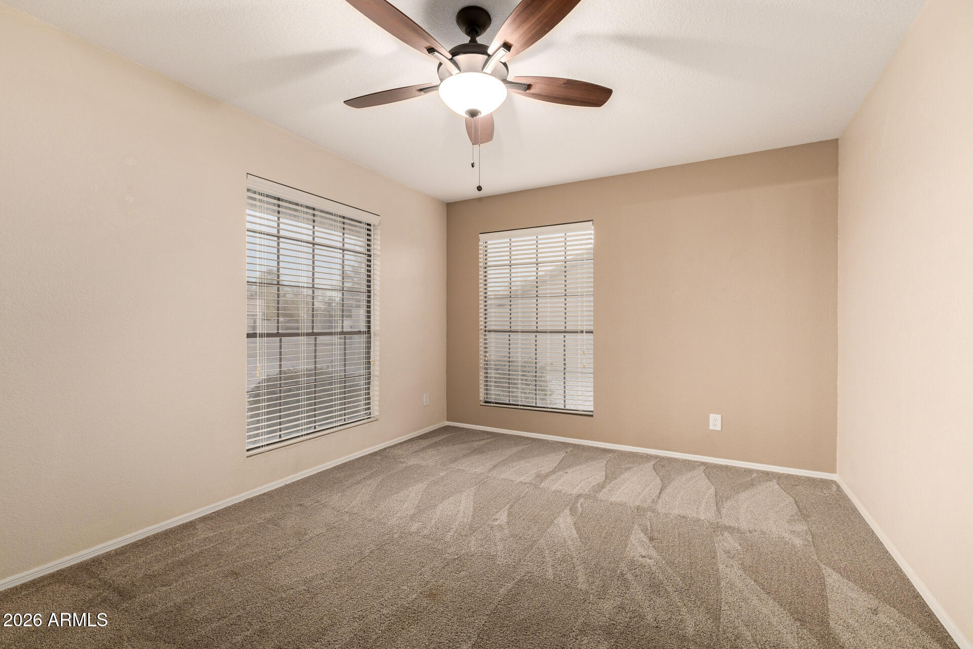 1522 N Spring Mesa, AZ 85203 - Photo 24 of 63 an empty room with windows and ceiling fan