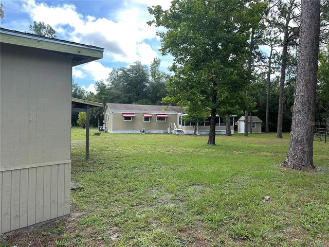 a backyard of a house with lots of green space