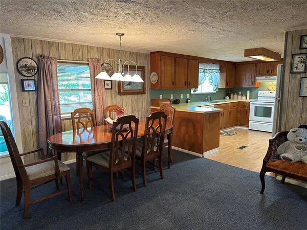 a view of a dining room with furniture and window
