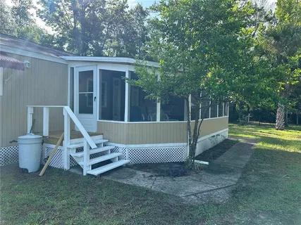 a view of a house with pool and a yard