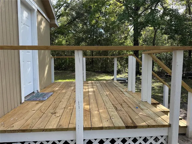a view of a house with wooden deck