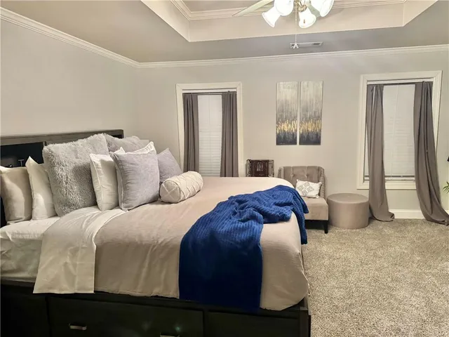 a bedroom with a large bed and a chandelier