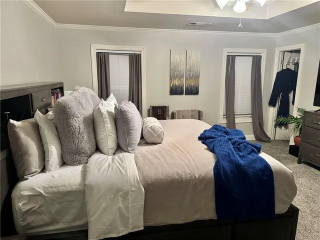 a bed room with two bed and a mirror