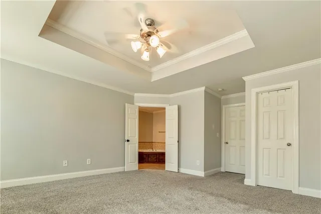 wooden floor in an empty room with a chandelier fan
