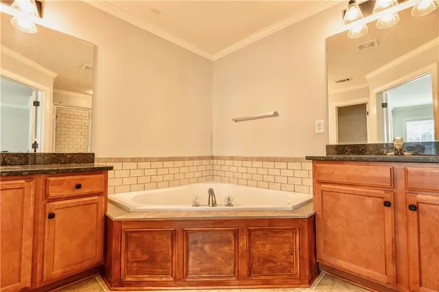 a bathroom with a tub sink and mirror