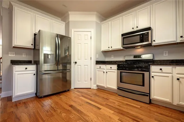 a kitchen with a refrigerator stove and microwave