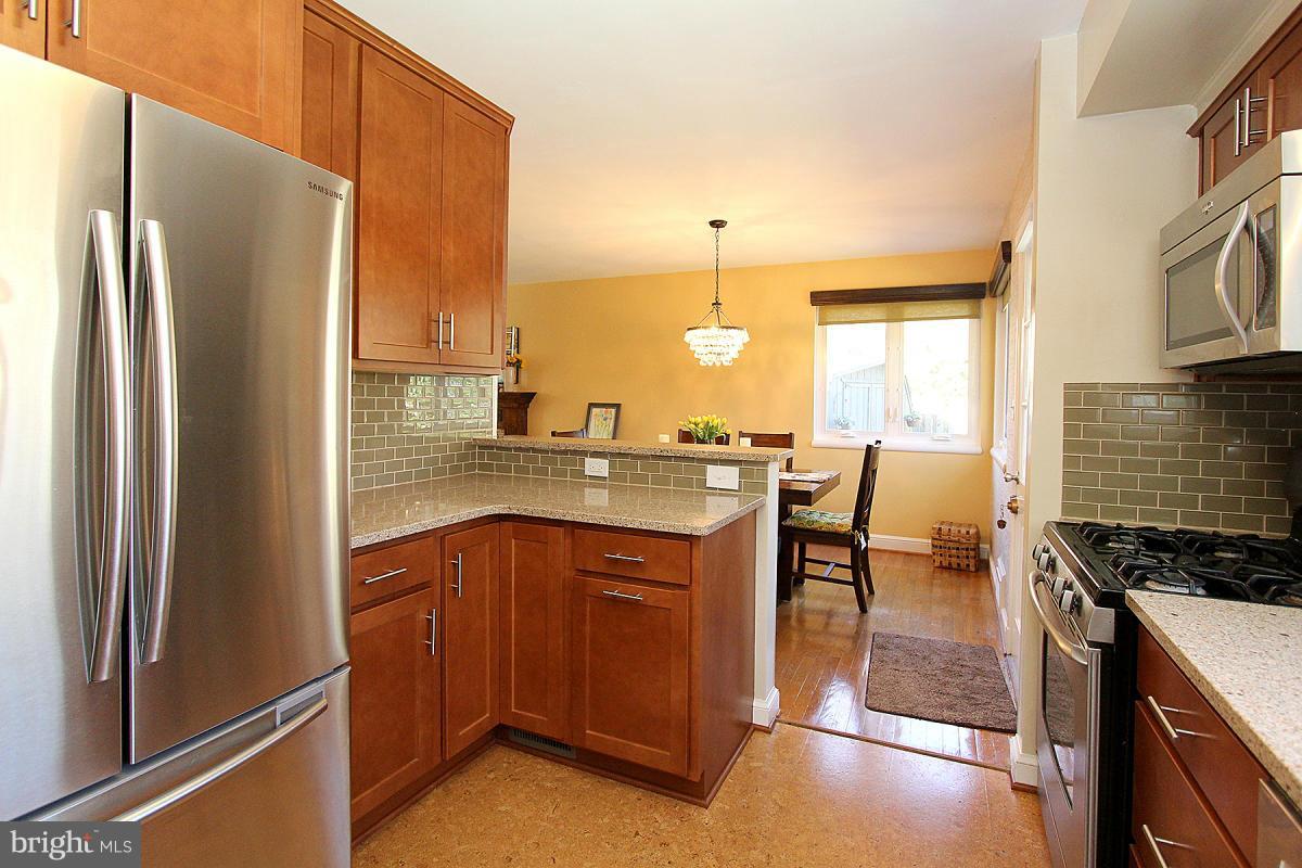109 Belton Road Silver Spring, MD 20901 - Photo 12 of 30 a kitchen with stainless steel appliances granite countertop a refrigerator a stove and a sink