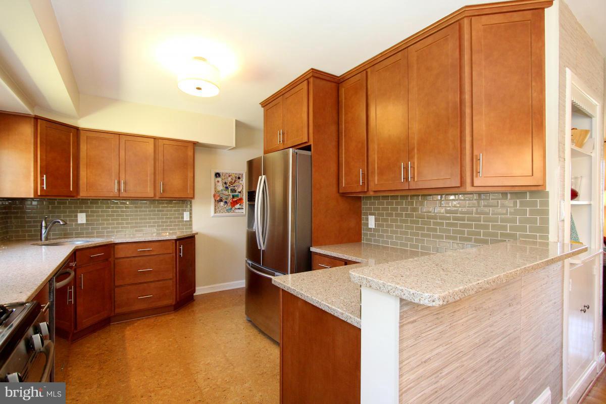 109 Belton Road Silver Spring, MD 20901 - Photo 13 of 30 a kitchen with stainless steel appliances granite countertop a refrigerator and a sink