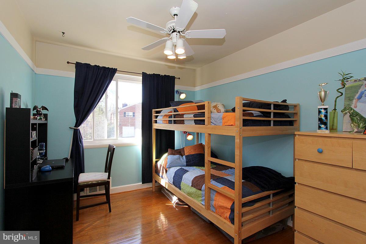 109 Belton Road Silver Spring, MD 20901 - Photo 15 of 30 a bedroom with a bed and a chandelier