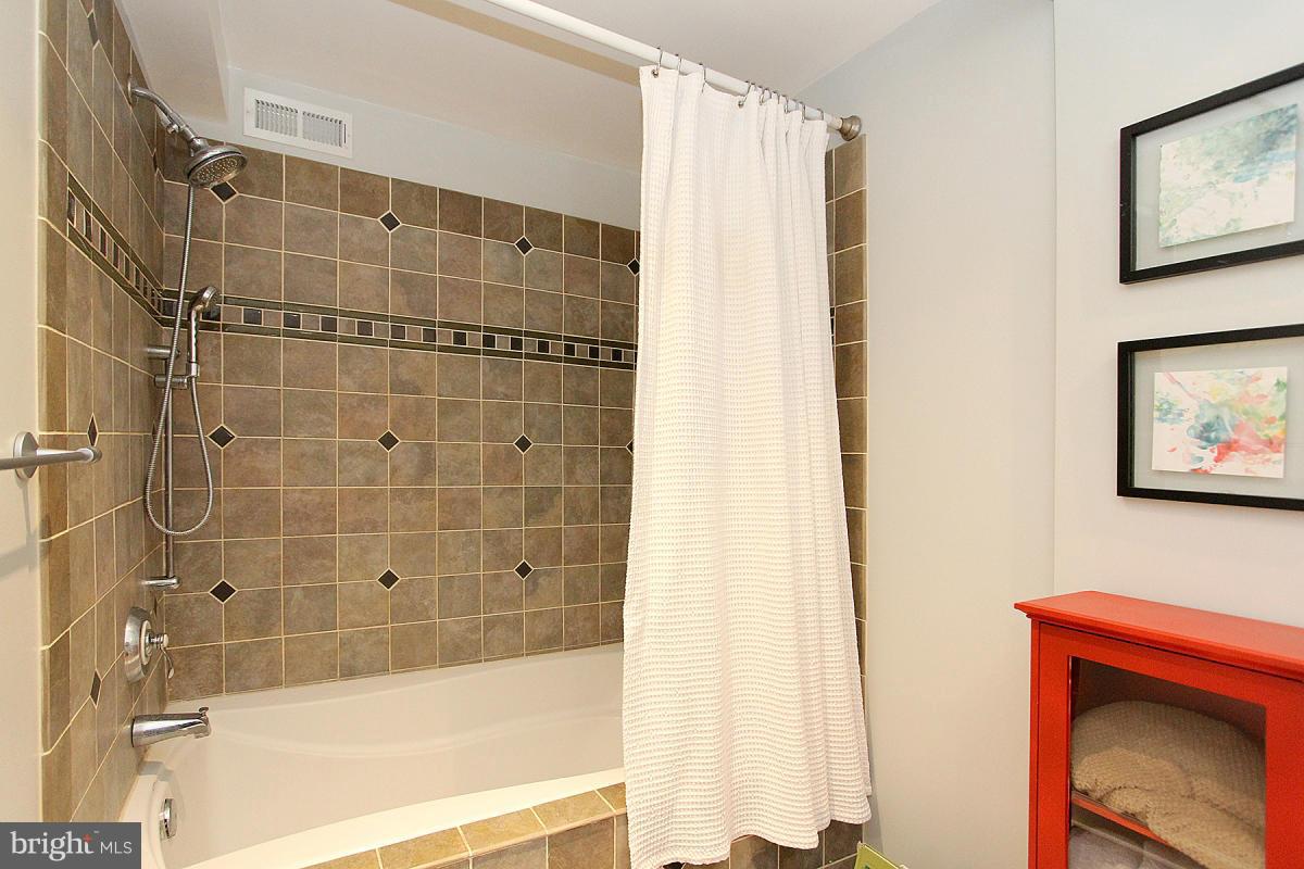 109 Belton Road Silver Spring, MD 20901 - Photo 22 of 30 a bathroom with a shower and a bath tub