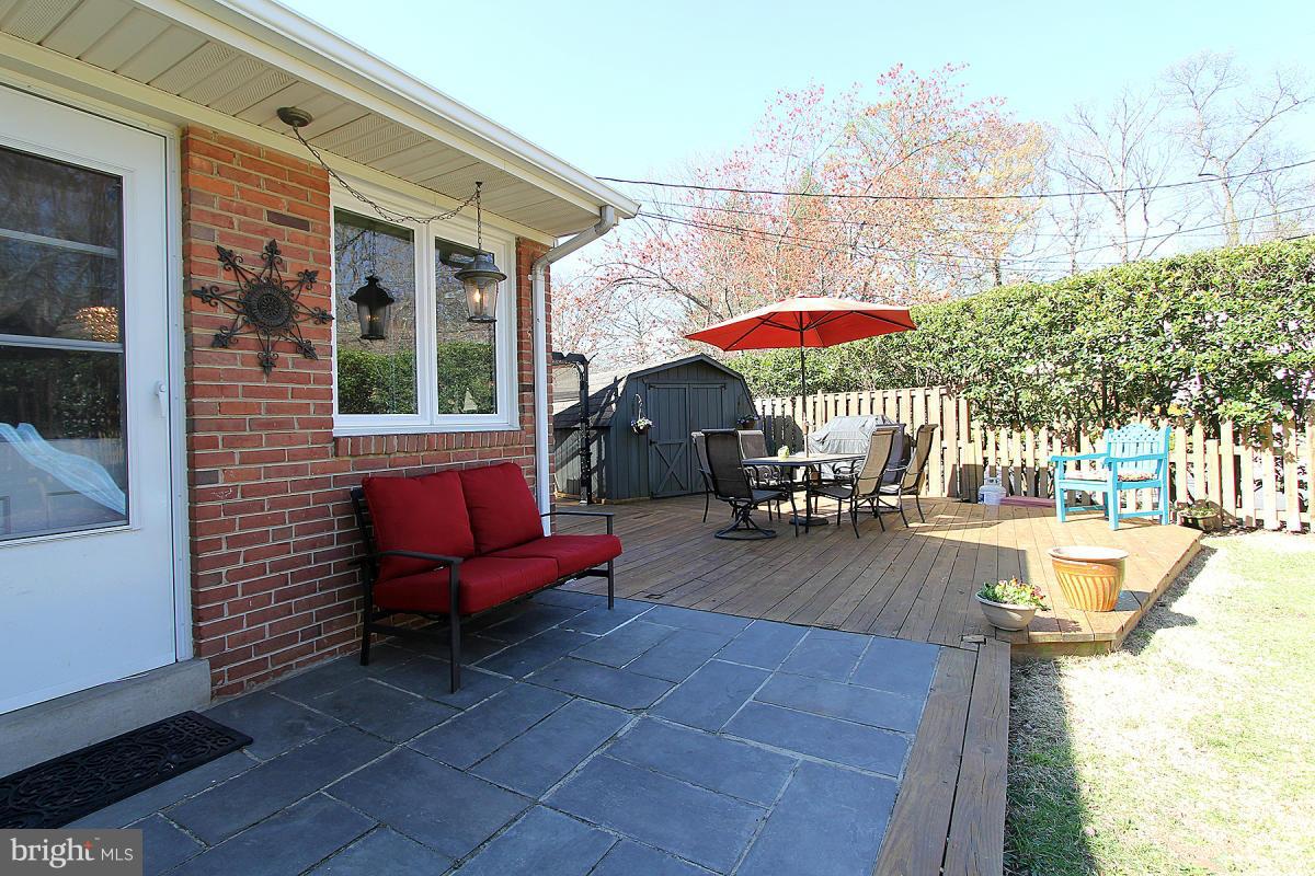 109 Belton Road Silver Spring, MD 20901 - Photo 24 of 30 a view of a patio with a table and chairs under an umbrella