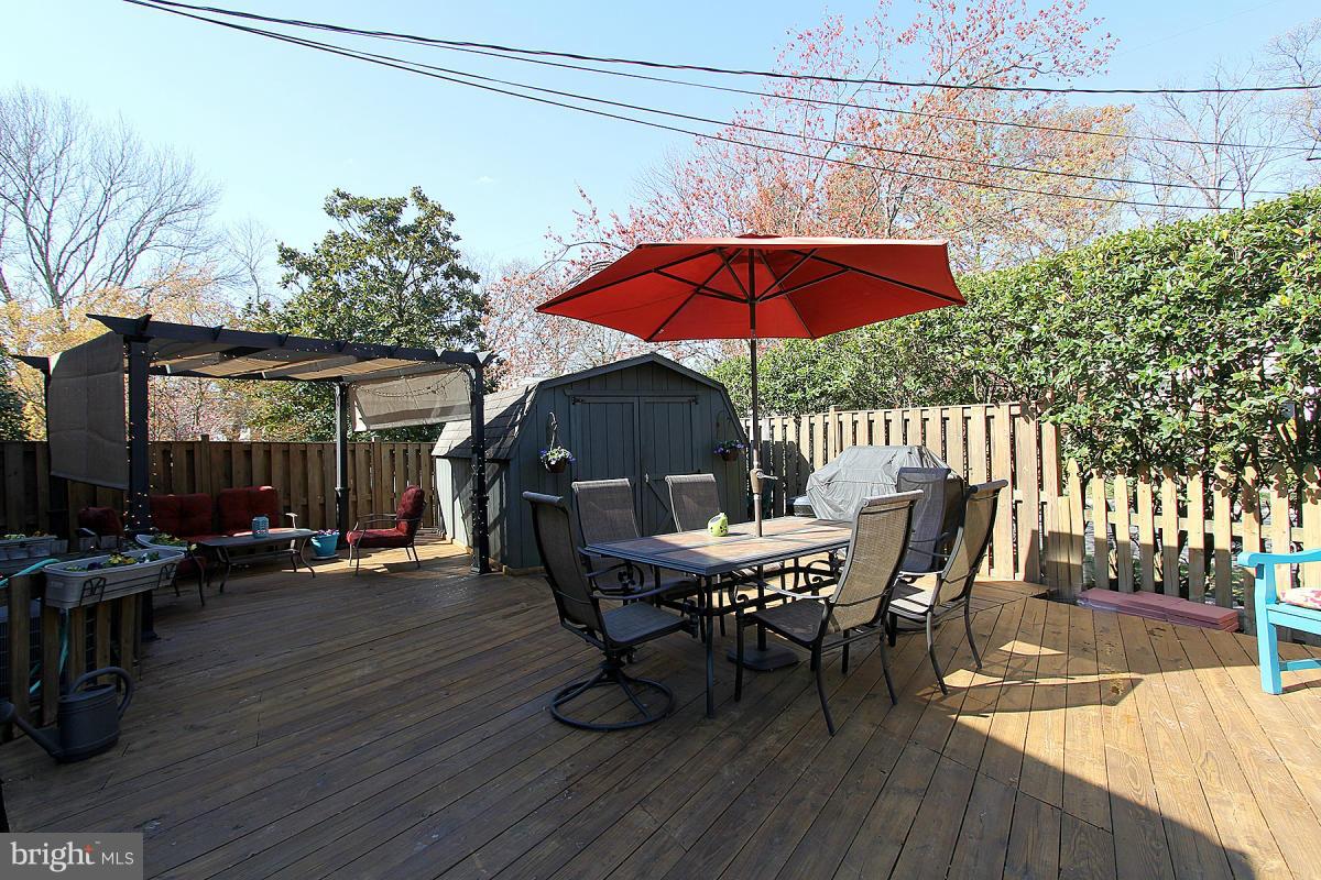 109 Belton Road Silver Spring, MD 20901 - Photo 25 of 30 a view of a house with a table and chairs under an umbrella