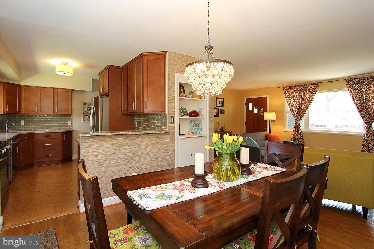 109 Belton Road Silver Spring, MD 20901 - Photo 8 of 30 a view of a dining room with furniture a chandelier and wooden floor