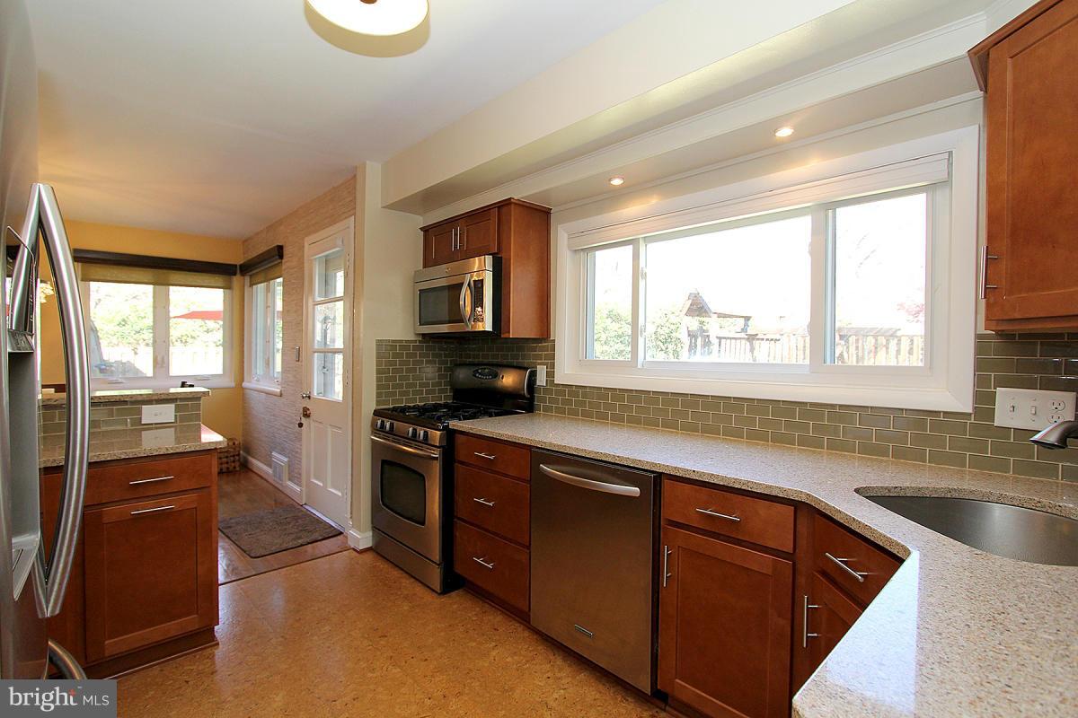 109 Belton Road Silver Spring, MD 20901 - Photo 10 of 30 a large kitchen with stainless steel appliances granite countertop a sink and a stove