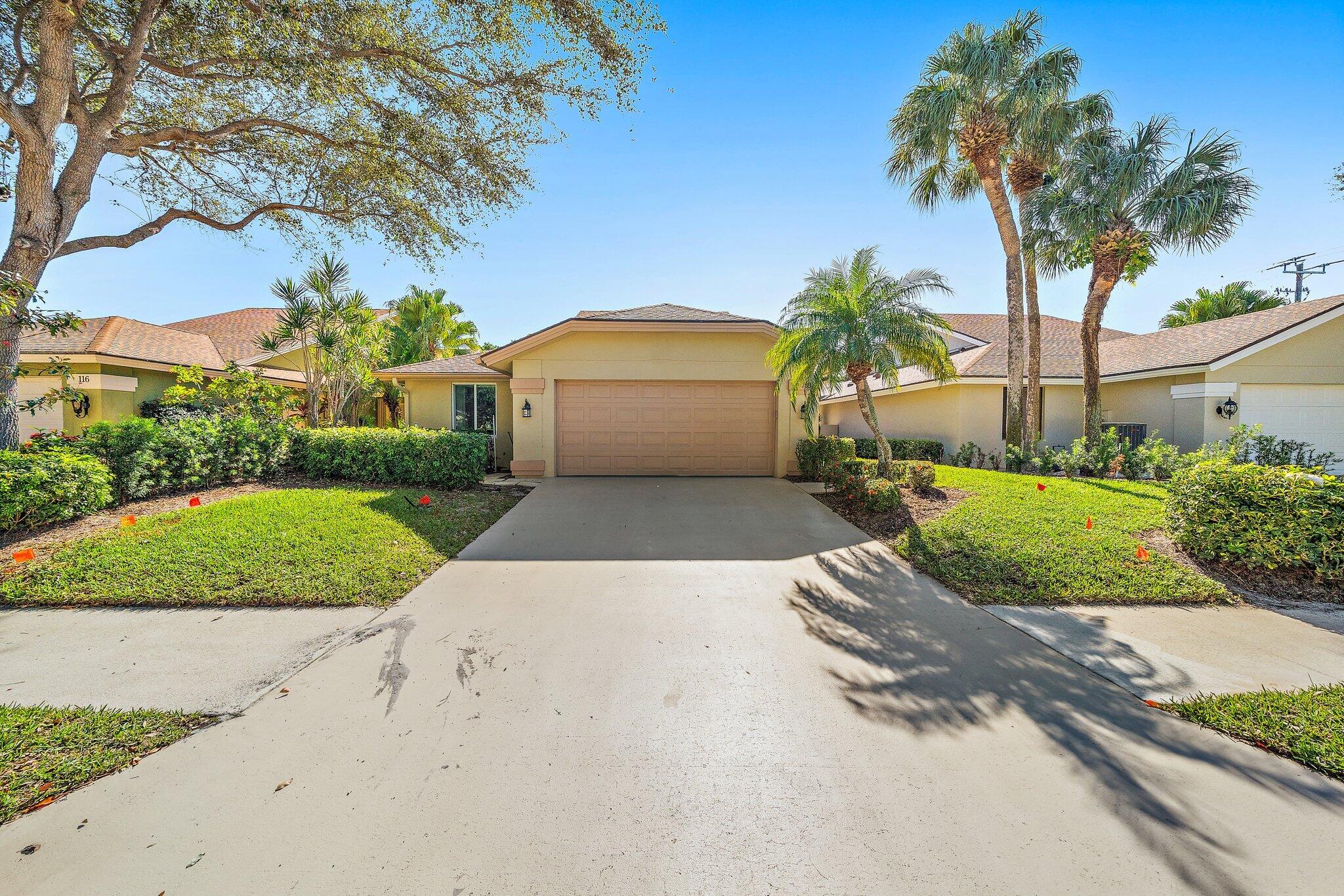 126 Cape Pointe Circle Jupiter, FL 33477 - Photo 4 of 4 a view of a house with a yard and garage