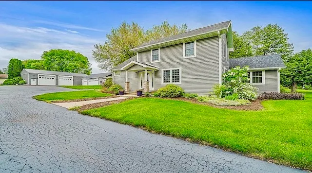 a front view of house with yard and green space