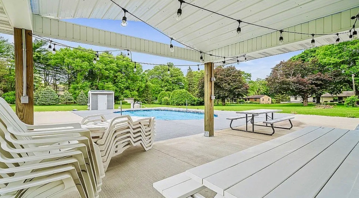 2912 Woodlawn Road Sterling, IL 61081 - Photo 11 of 48 a view of a patio with table and chairs potted plants with wooden floor