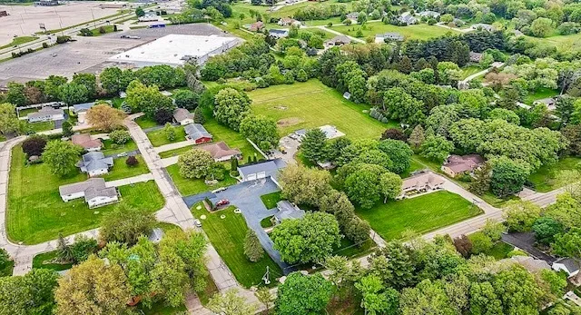 an aerial view of residential houses with outdoor space and street view