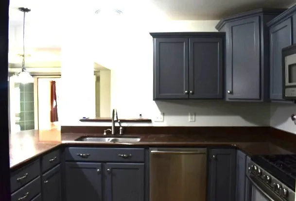 a kitchen with stainless steel appliances granite countertop a sink a stove and a microwave oven