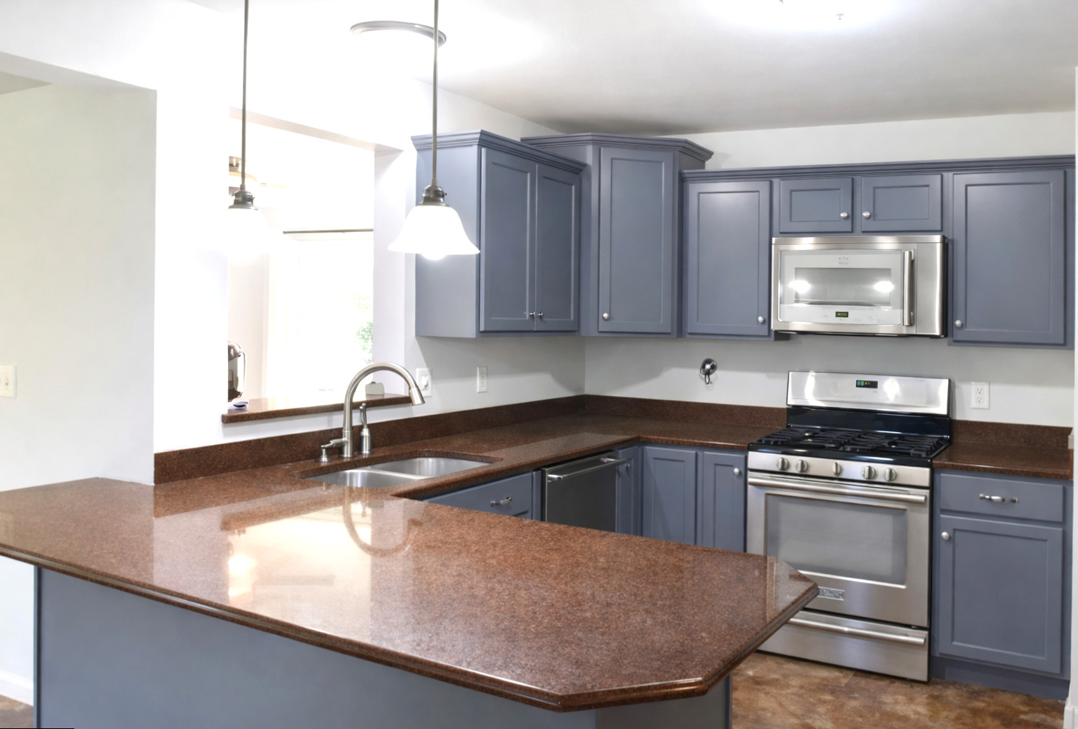 2912 Woodlawn Road Sterling, IL 61081 - Photo 34 of 48 a kitchen with kitchen island granite countertop a sink a stove and cabinets
