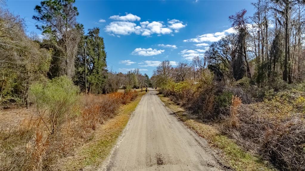 Southwest 136th Street Starke, FL 32091 - Photo 16 of 16 a view of a pathway with a wrought fence
