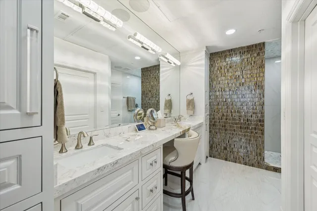 a spacious bathroom with double vanity and a shower