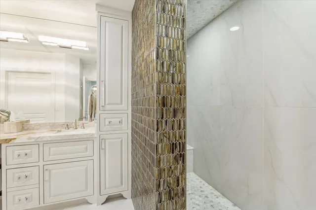 a bathroom with a shower and a sink