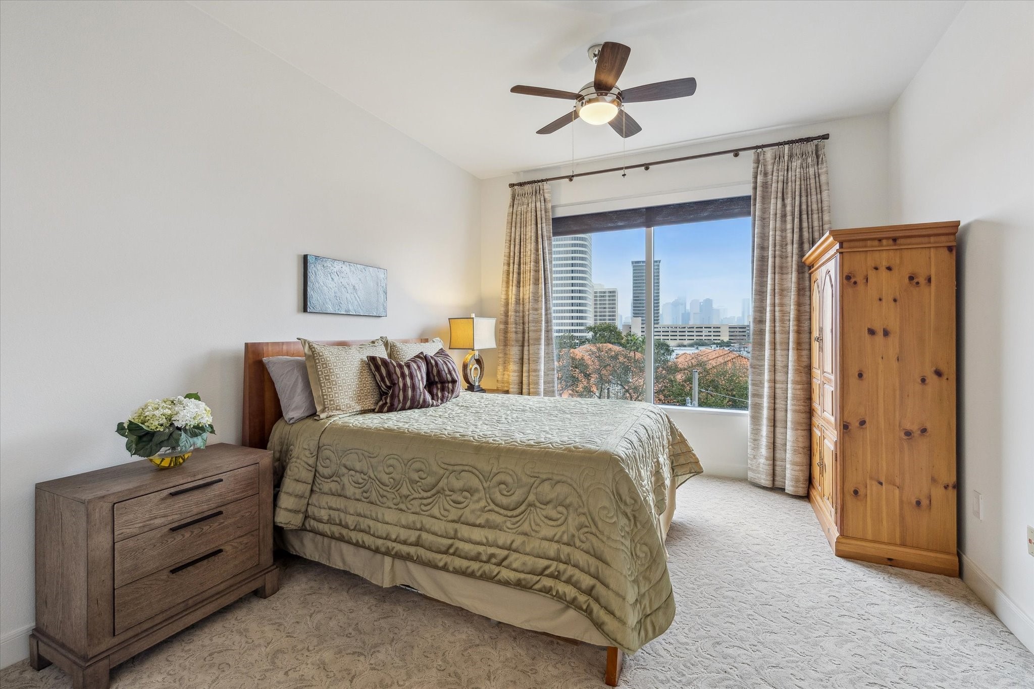 3333 Allen Parkway, Unit 602 Houston, TX 77019 - Photo 19 of 49 a spacious bedroom with a bed and a chandelier