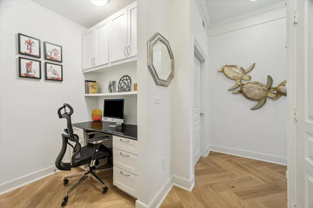 a view of a workspace with furniture and a window