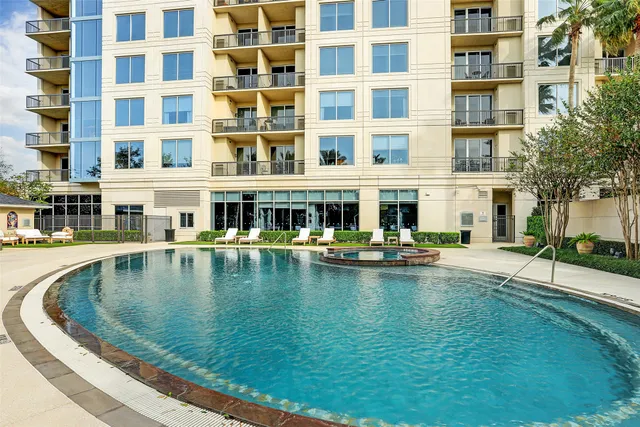 a view of swimming pool with outdoor seating and plants
