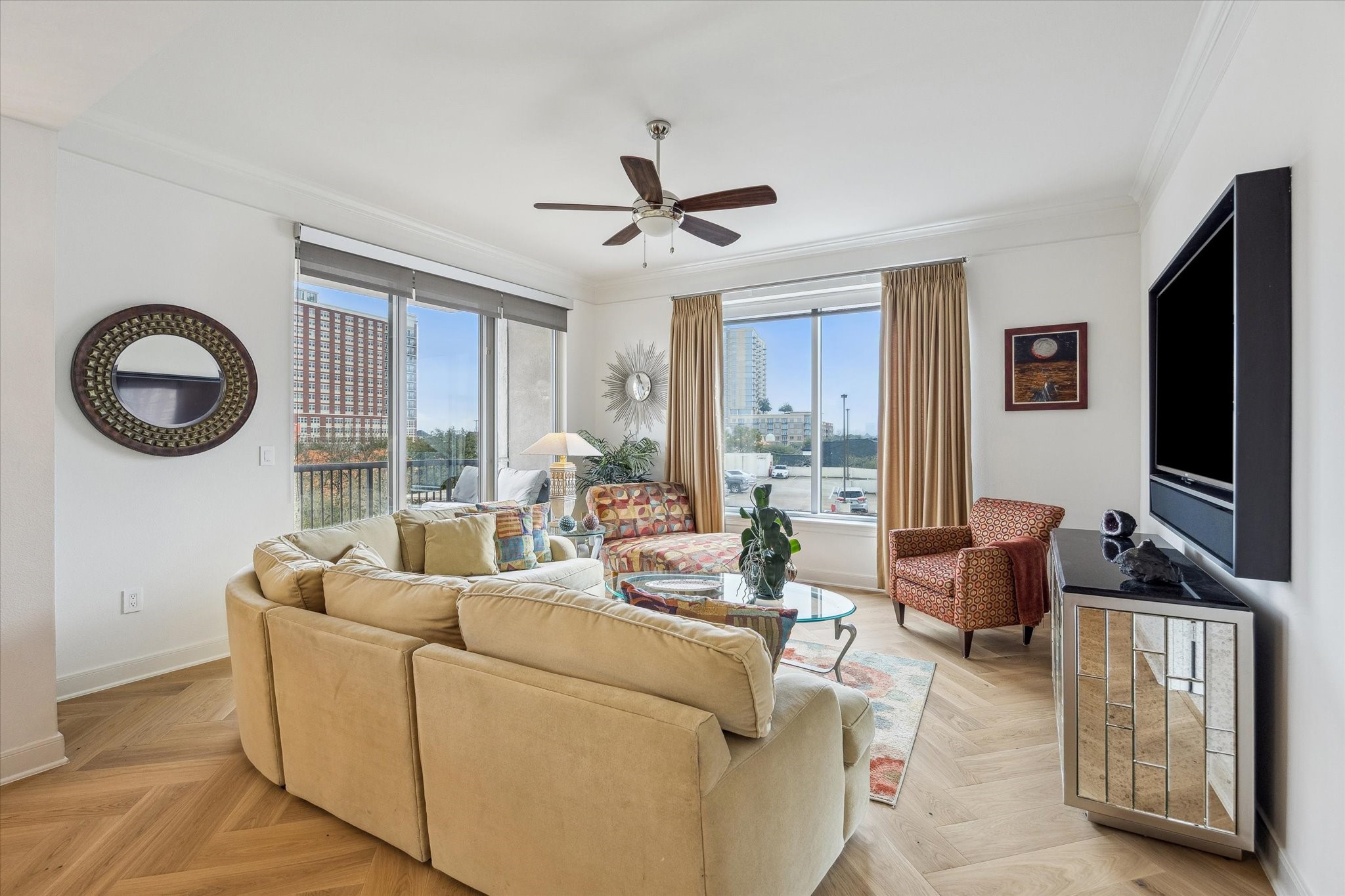 3333 Allen Parkway, Unit 602 Houston, TX 77019 - Photo 9 of 49 a living room with furniture a flat screen tv and a large window
