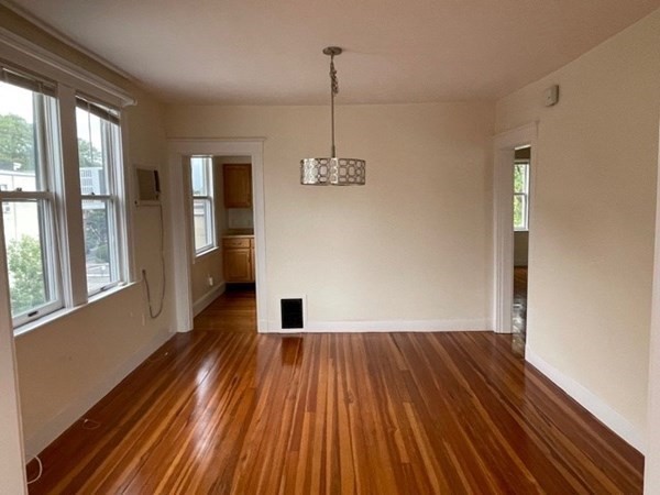 95 Allston Street, Unit 3 Cambridge, MA 02139 - Photo 3 of 12 a view of empty room with wooden floor and windows