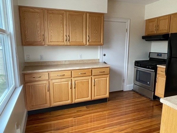 95 Allston Street, Unit 3 Cambridge, MA 02139 - Photo 6 of 12 a kitchen with stainless steel appliances granite countertop a sink a stove and a refrigerator