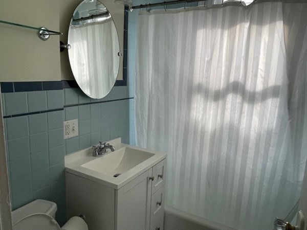95 Allston Street, Unit 3 Cambridge, MA 02139 - Photo 10 of 12 a bathroom with a sink and mirror