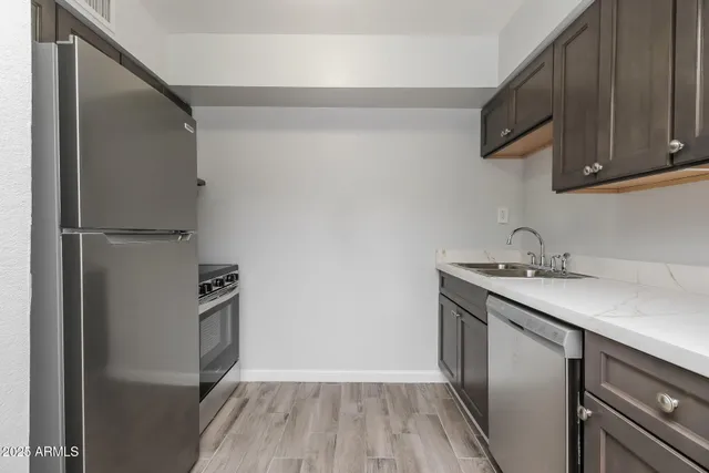 a kitchen with a sink and a refrigerator