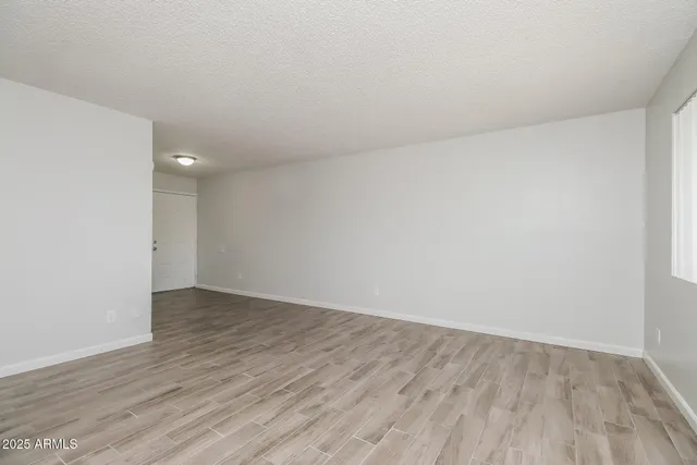 a view of an empty room and wooden floor