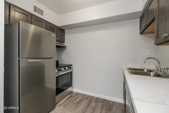 a kitchen with a refrigerator and a sink
