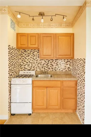 a view of a bathroom with granite countertop white cabinets and a sink