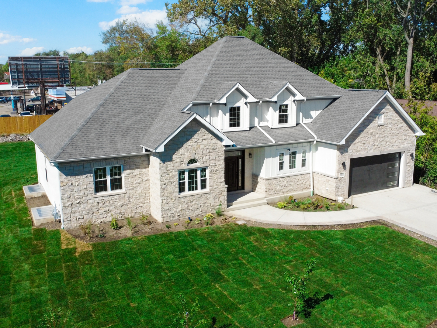 a aerial view of a house next to a yard