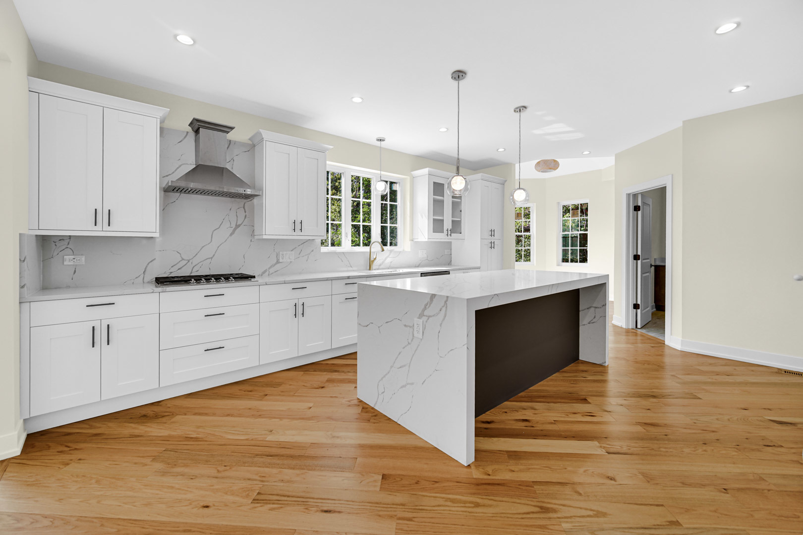 602 Glenshire Road Glenview, IL 60025 - Photo 25 of 98 a large kitchen with stainless steel appliances kitchen island granite countertop a stove a sink a refrigerator and white cabinets with wooden floor