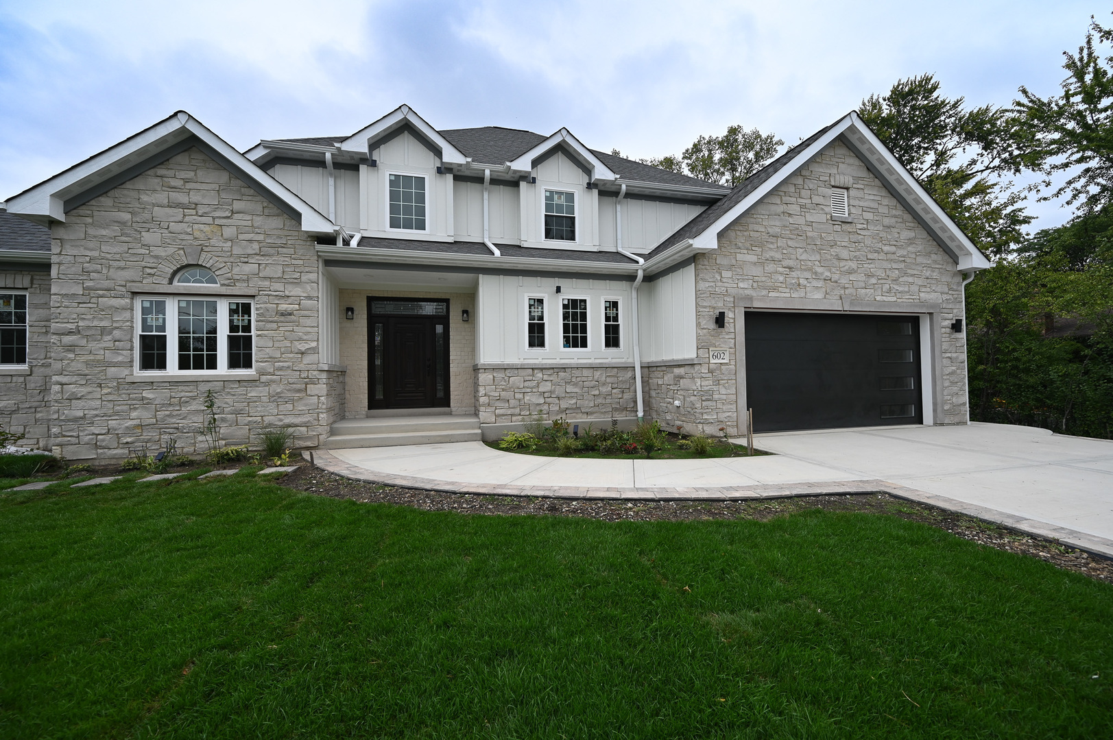 602 Glenshire Road Glenview, IL 60025 - Photo 10 of 98 a front view of a house with a yard and garage