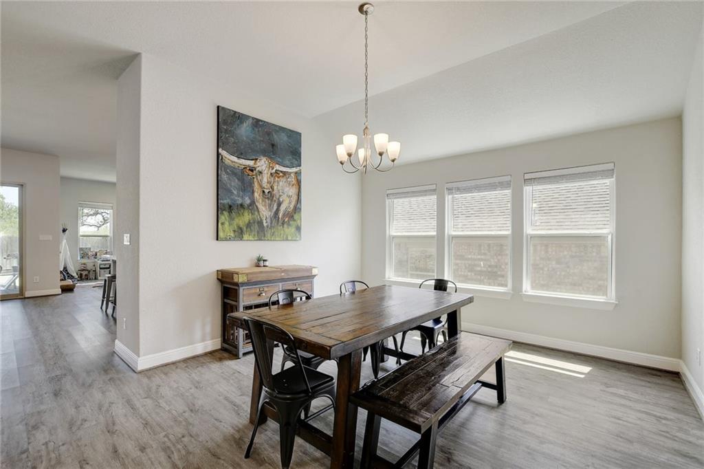 416 Peakside Circle Dripping Springs, TX 78620 - Photo 11 of 31 a view of a dining room with furniture window and wooden floor