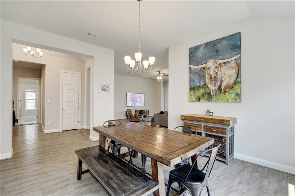 416 Peakside Circle Dripping Springs, TX 78620 - Photo 12 of 31 a view of a dining room with furniture and a chandelier