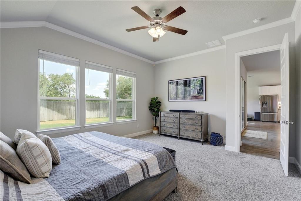 416 Peakside Circle Dripping Springs, TX 78620 - Photo 18 of 31 a bedroom with a bed and a large window