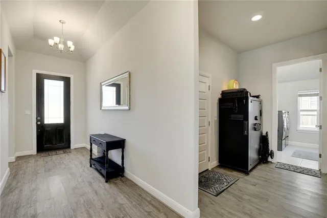 wooden floor and windows in a room with a mirror