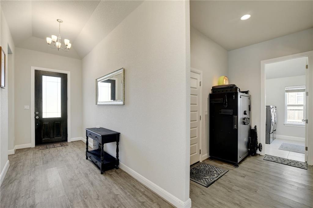 416 Peakside Circle Dripping Springs, TX 78620 - Photo 22 of 31 wooden floor and windows in a room with a mirror