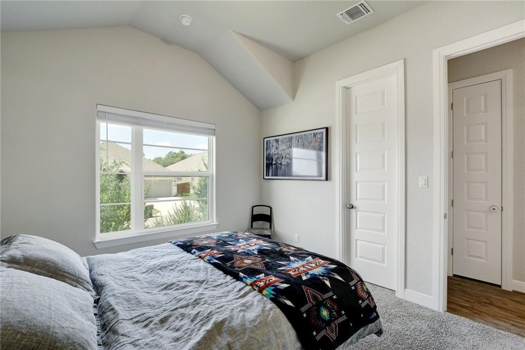 416 Peakside Circle Dripping Springs, TX 78620 - Photo 24 of 31 a bedroom with a bed and a window