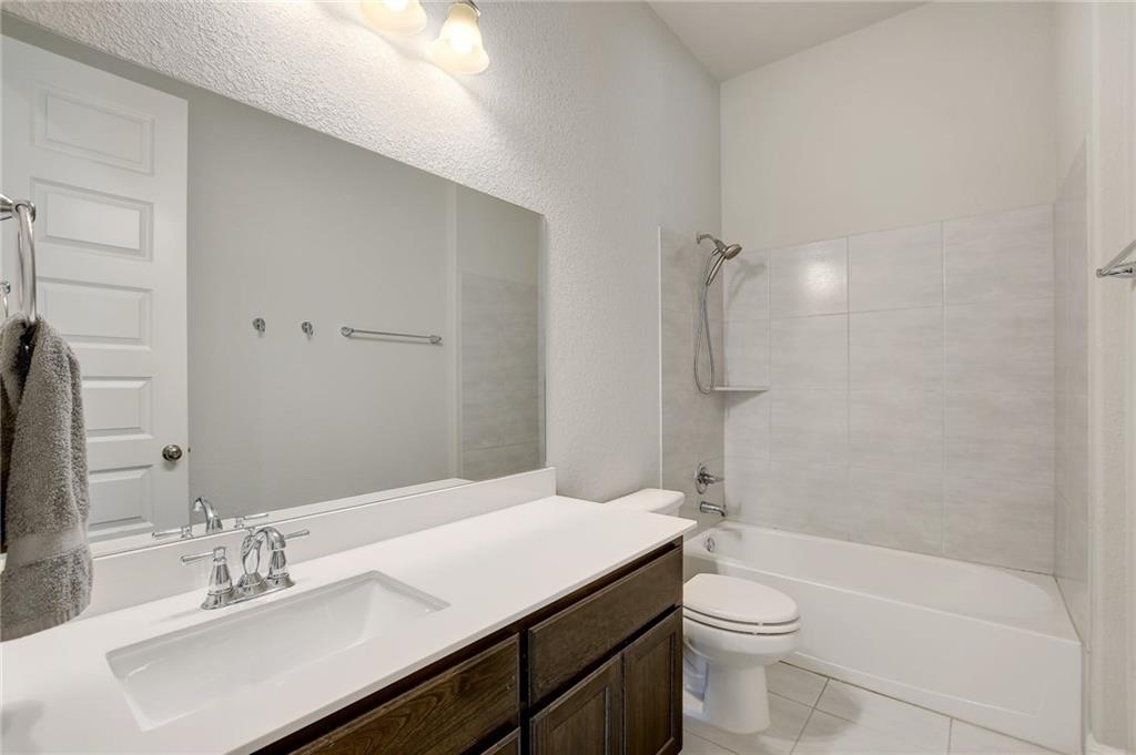 416 Peakside Circle Dripping Springs, TX 78620 - Photo 26 of 31 a bathroom with a sink a toilet and shower