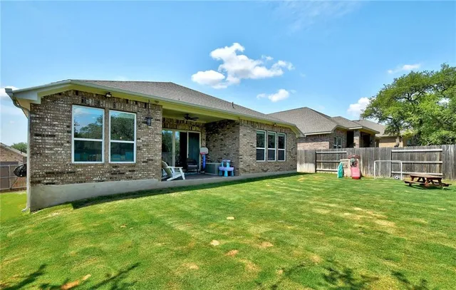 a view of a house with a backyard porch and sitting area